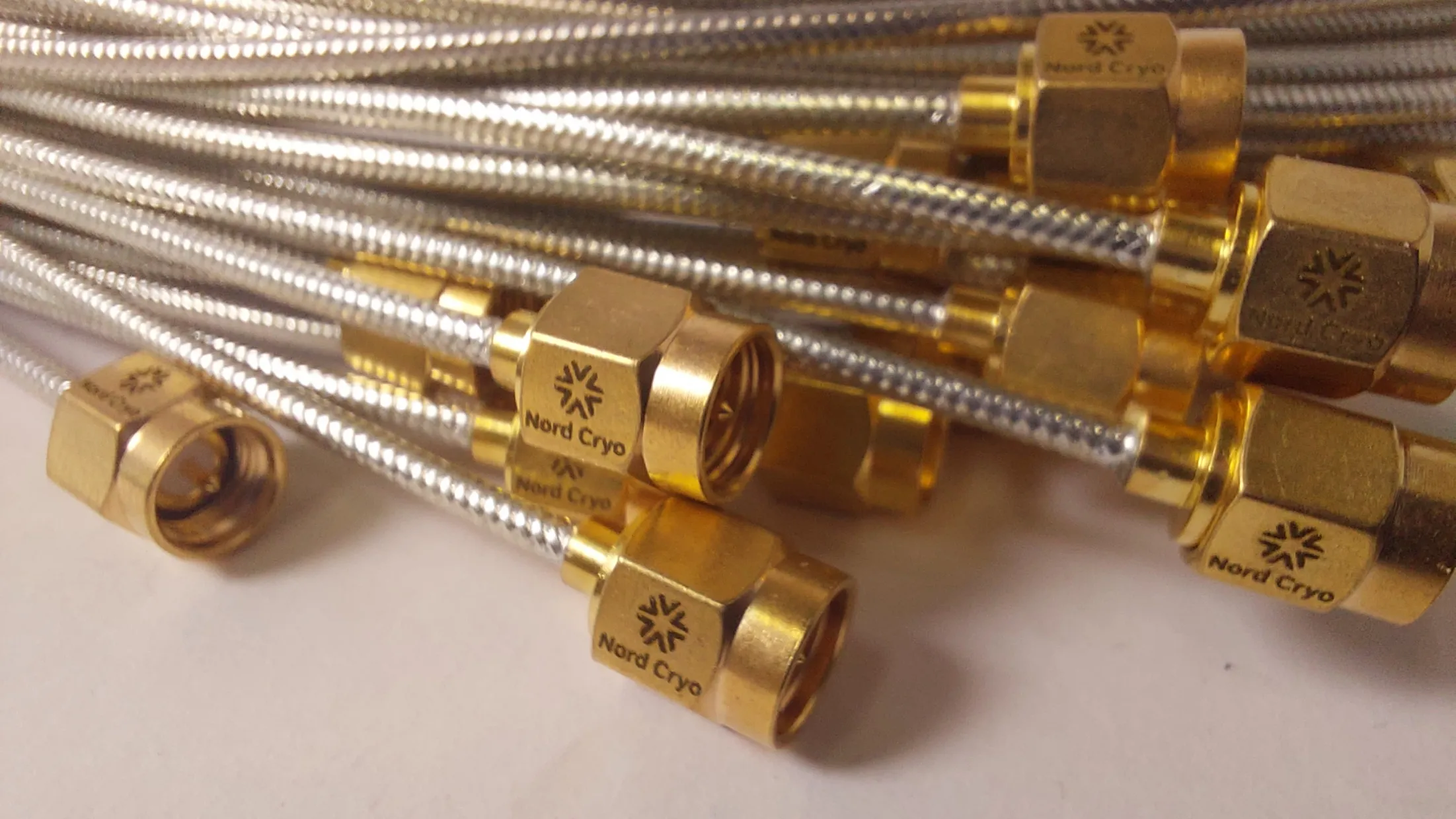 Cryogenic low-thermal-conductivity coaxial cables
